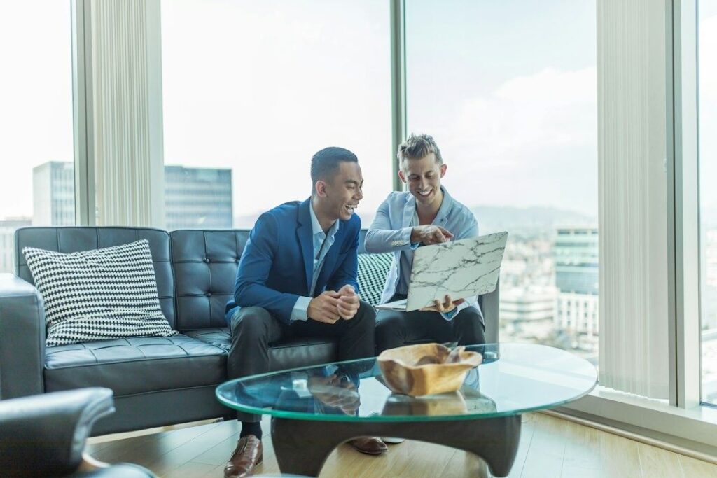 Two professionals reviewing a document in a bright office lounge